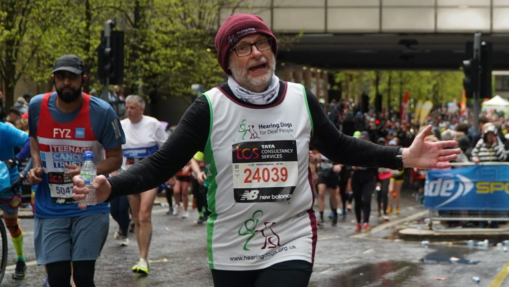 Runner clebrating in hearing dogs running vests