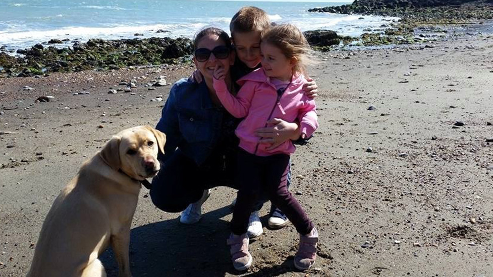 Debbie with her children and hearing dog Clover