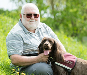 hearing dog Theo helping John