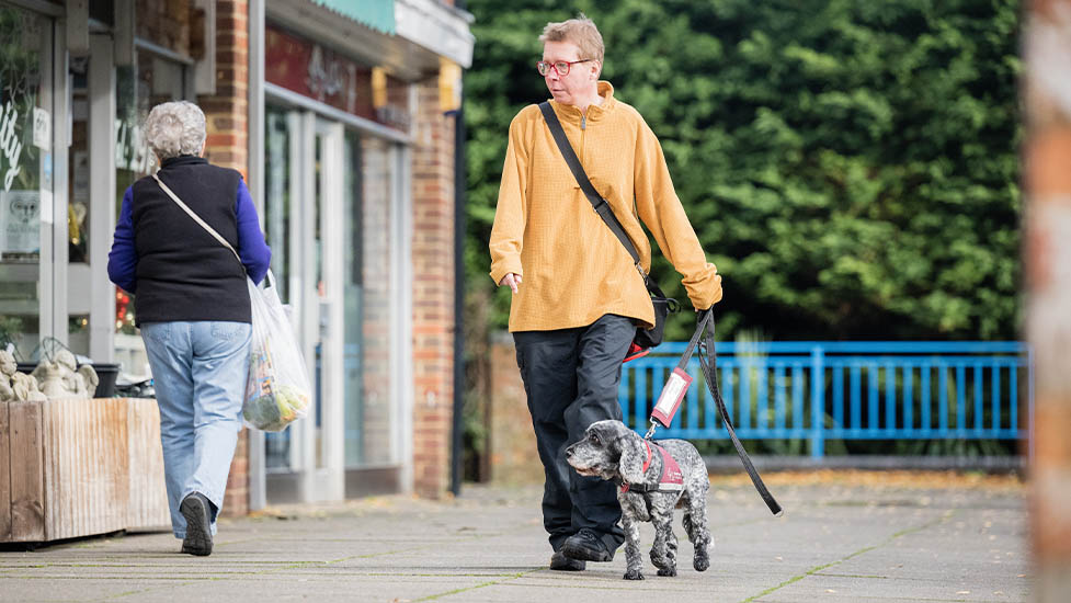 Lorna and cocker spaniel Belle are walking past a parade of shops