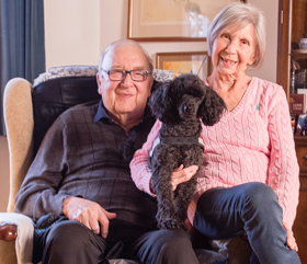 hearing dog helping elderly couple