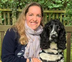 A woman with a black and white cocker spaniel dog
