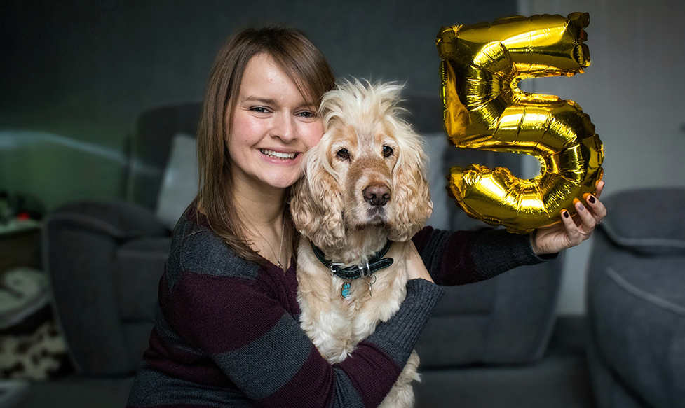 Sarah and hearing dog Albert laying down together