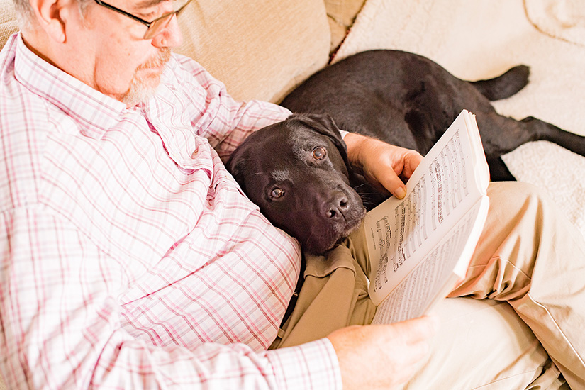 Chris and his hearing dog Rom relaxing