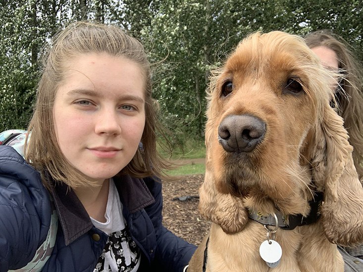 A close up of Trinity and her hearing dog Alvin