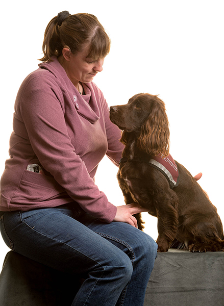 Jen sitting next to hearing dog Dram