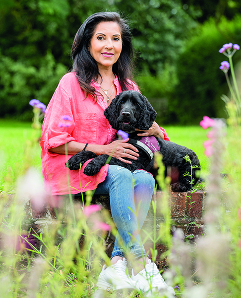 Shmita and her hearing dog Harris sitting outside