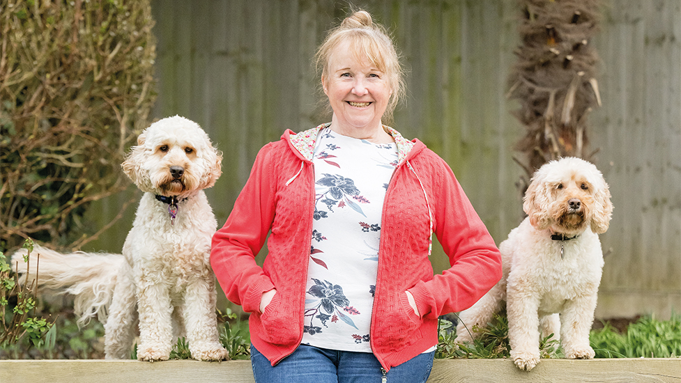 Janice with new hearing dog Humphrey (left) and retired hearing dog Marti (right)
