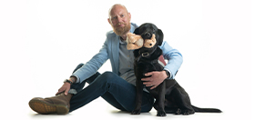 Ian and his hearing dog - black Labrador Vectra
