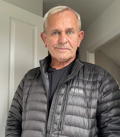 David is standing inside a house by a doorway