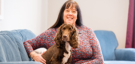 Chocolate cocker spaniel hearing dog Rico and his deaf partner Sandra