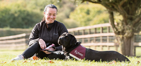 Lisa and her black labrador hearing dog