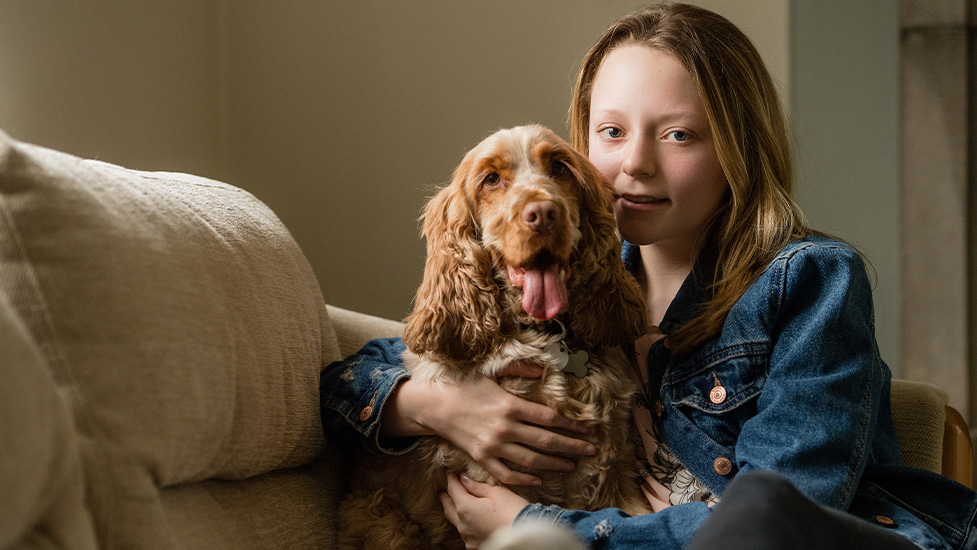 Amelia relaxing with her hearing dog Scamp