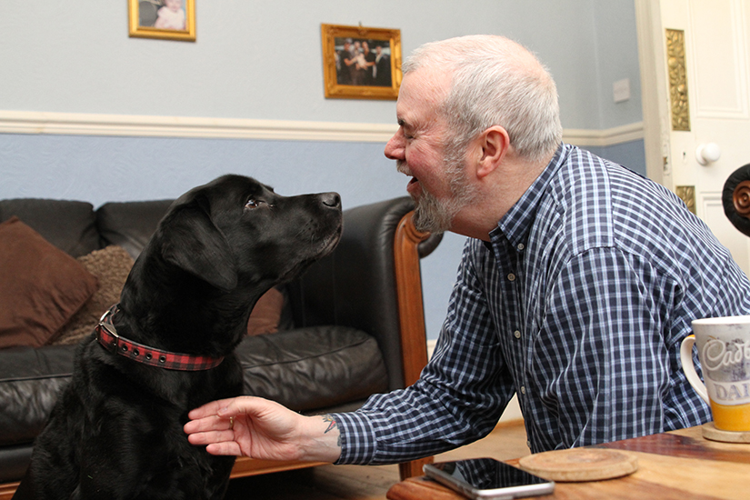 Garry Bushell at home with sound support dog Ozzie